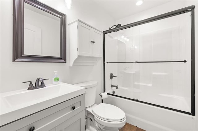 full bathroom with vanity, toilet, and enclosed tub / shower combo