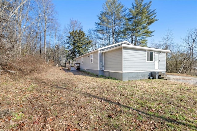 view of side of home featuring a lawn