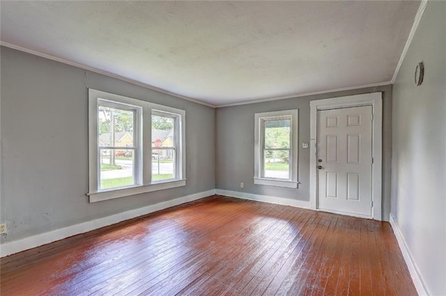 entrance foyer with wood-type flooring, crown molding, and baseboards