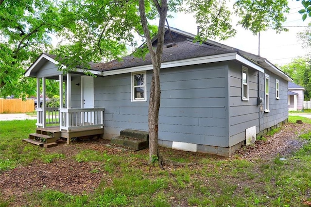 view of side of property featuring crawl space and fence