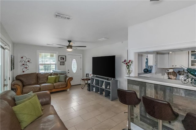 living room featuring ceiling fan and light tile patterned floors