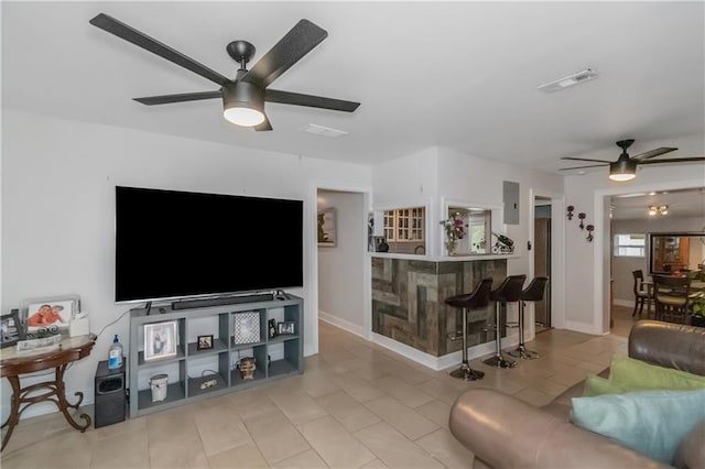 living room with ceiling fan and light tile patterned flooring