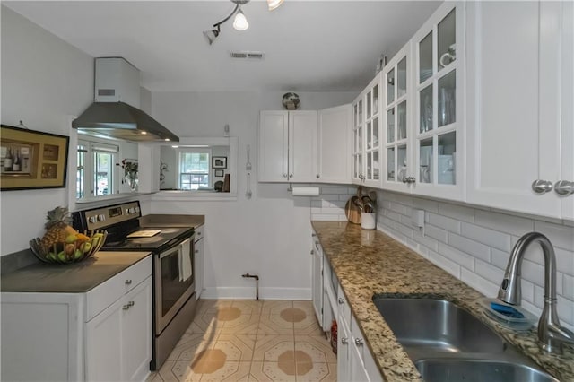 kitchen featuring backsplash, stainless steel range with electric cooktop, sink, light stone counters, and white cabinetry