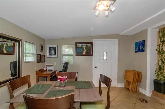 tiled dining room with lofted ceiling