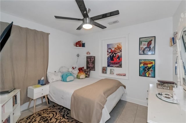 bedroom with ceiling fan and light tile patterned floors