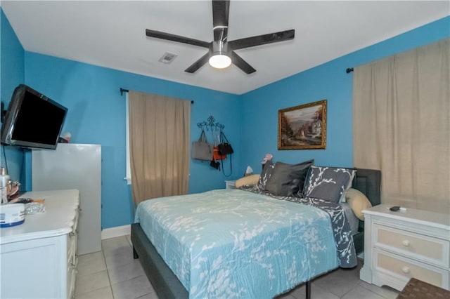 tiled bedroom featuring ceiling fan