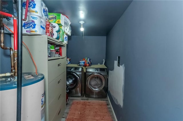 laundry room featuring washing machine and clothes dryer and water heater