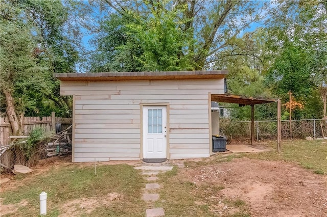 view of outbuilding with a yard