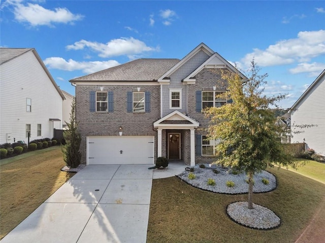 view of front of home with a front yard and a garage