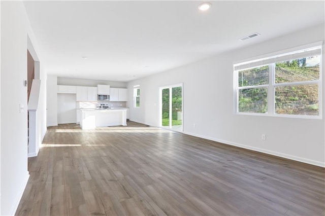 650 Cayenne Way, Lawrenceville, GA 30045 - unfurnished living room featuring baseboards, wood finished floors, and recessed lighting