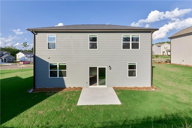 rear view of property with a patio area and a yard