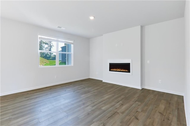 650 Cayenne Way, Lawrenceville, GA 30045 - unfurnished living room with wood finished floors, a lit fireplace, baseboards, and recessed lighting