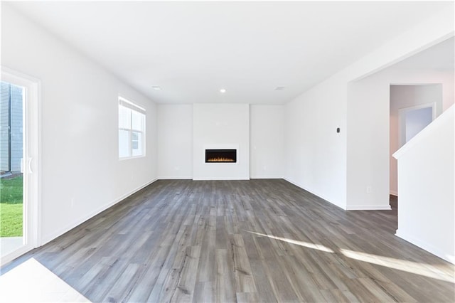 650 Cayenne Way, Lawrenceville, GA 30045 - unfurnished living room with wood finished floors, a warm lit fireplace, baseboards, and recessed lighting