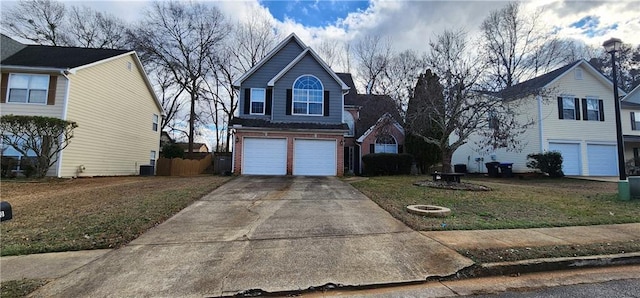 1230 Chris Lake Dr, Lawrenceville, GA 30046 - traditional home with a garage, brick siding, central AC unit, a front yard, and driveway