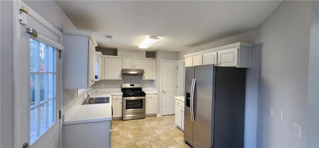 1230 Chris Lake Dr, Lawrenceville, GA 30046 - kitchen featuring appliances with stainless steel finishes, under cabinet range hood, a sink, light countertops, and white cabinets