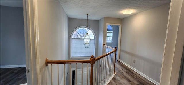 1230 Chris Lake Dr, Lawrenceville, GA 30046 - stairs with wood finished floors, a textured ceiling, a chandelier, and baseboards