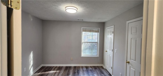 1230 Chris Lake Dr, Lawrenceville, GA 30046 - unfurnished room with dark wood-style flooring, a textured ceiling, and baseboards