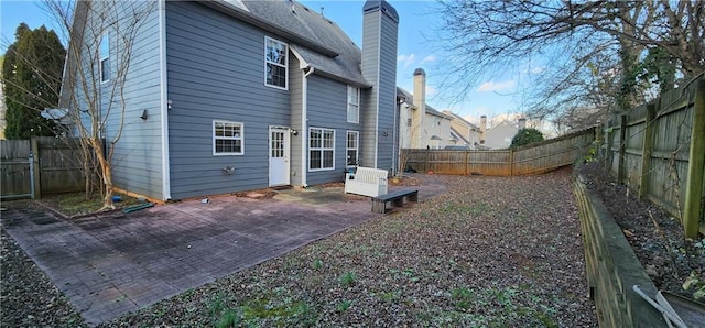 1230 Chris Lake Dr, Lawrenceville, GA 30046 - back of house featuring a chimney, a patio area, and a fenced backyard