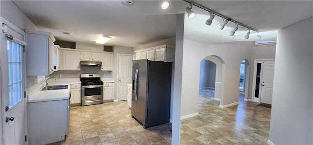 1230 Chris Lake Dr, Lawrenceville, GA 30046 - kitchen featuring fridge with ice dispenser, stainless steel range with gas cooktop, a sink, under cabinet range hood, and light countertops