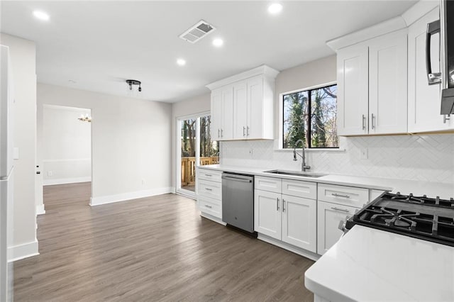 kitchen with white cabinetry, sink, dark wood-type flooring, and stainless steel dishwasher