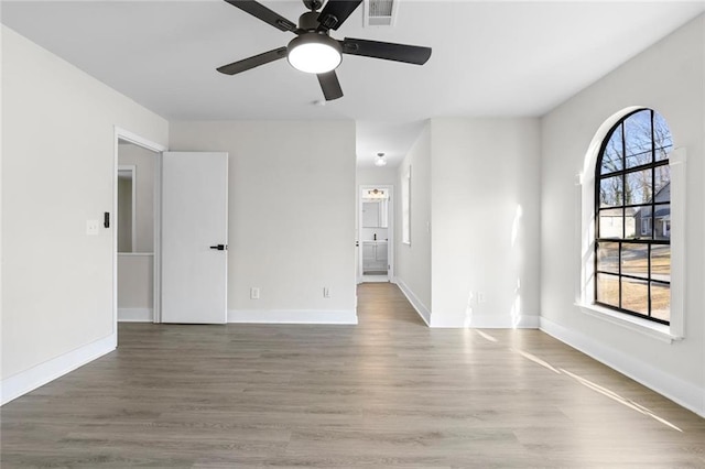 empty room with ceiling fan and hardwood / wood-style floors