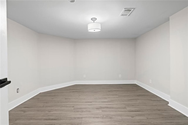 spare room featuring wood-type flooring