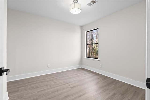 unfurnished room with hardwood / wood-style floors