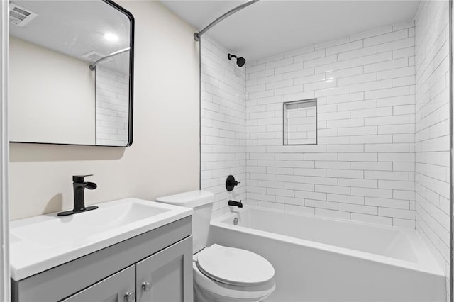 full bathroom with tiled shower / bath, vanity, and toilet