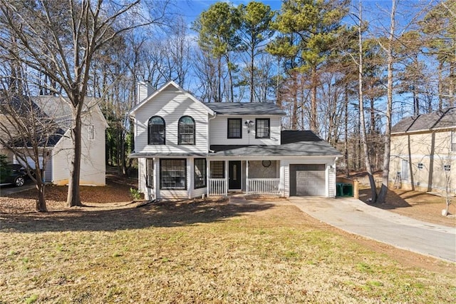 view of front of property with a garage, a front yard, and a porch