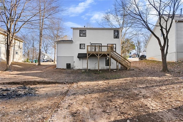 rear view of house with a wooden deck and central AC