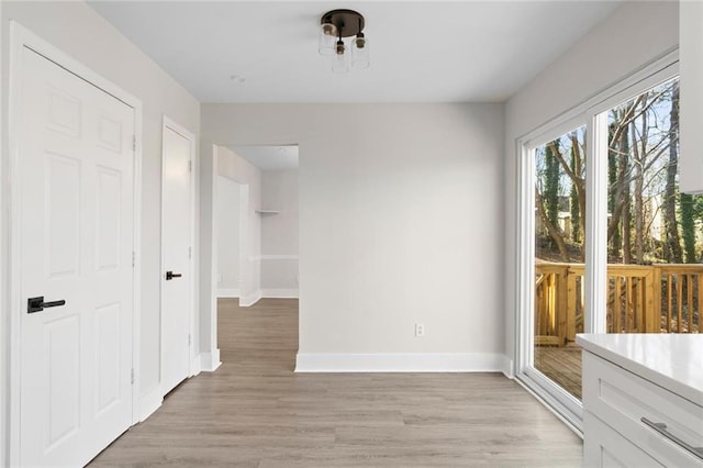 unfurnished dining area with light hardwood / wood-style flooring