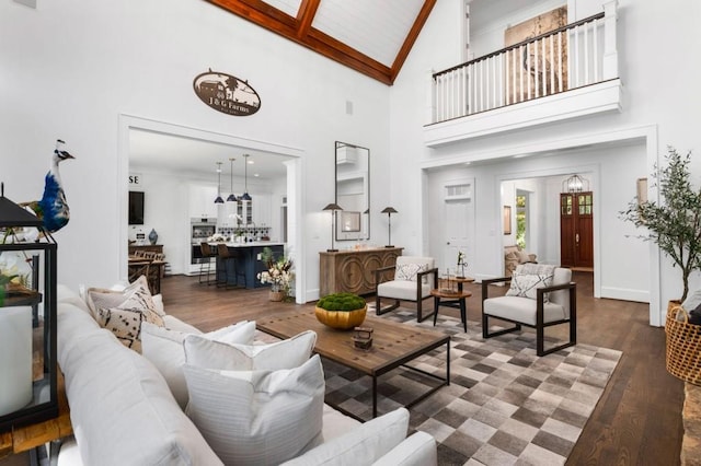 living room featuring high vaulted ceiling and wood-type flooring