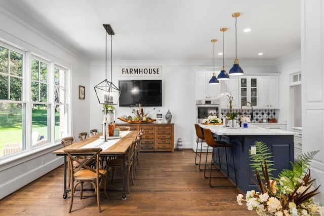 dining area with crown molding and dark hardwood / wood-style floors