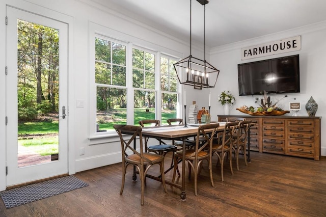 dining area with a wealth of natural light, dark wood-type flooring, crown molding, and a chandelier