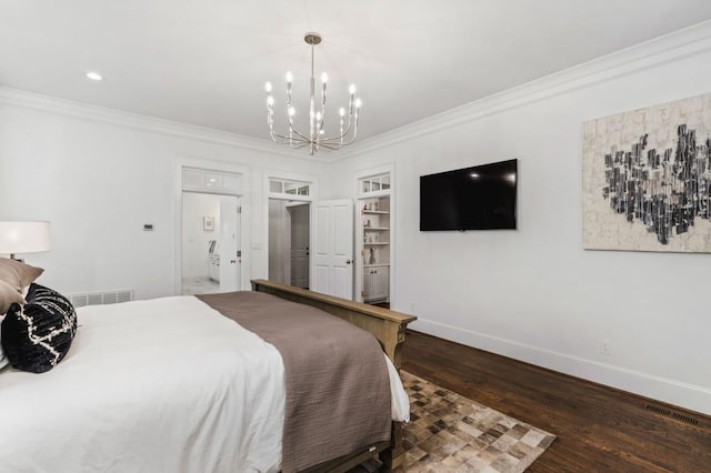 bedroom with connected bathroom, a notable chandelier, ornamental molding, and dark hardwood / wood-style flooring