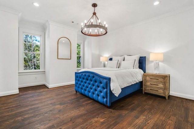 bedroom featuring crown molding, dark hardwood / wood-style flooring, and a chandelier