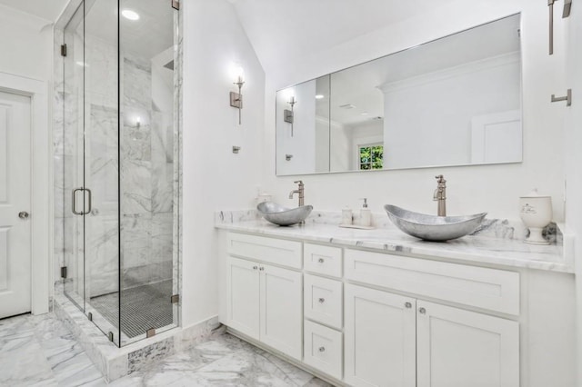 bathroom with vanity and a shower with door