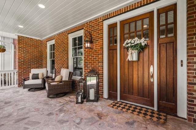 view of exterior entry with covered porch