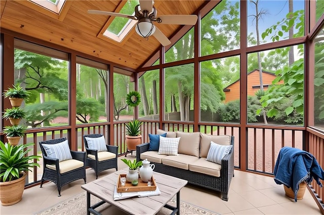 sunroom featuring a skylight, ceiling fan, vaulted ceiling, and an outdoor hangout area