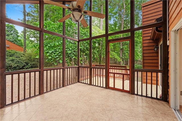 unfurnished sunroom featuring ceiling fan