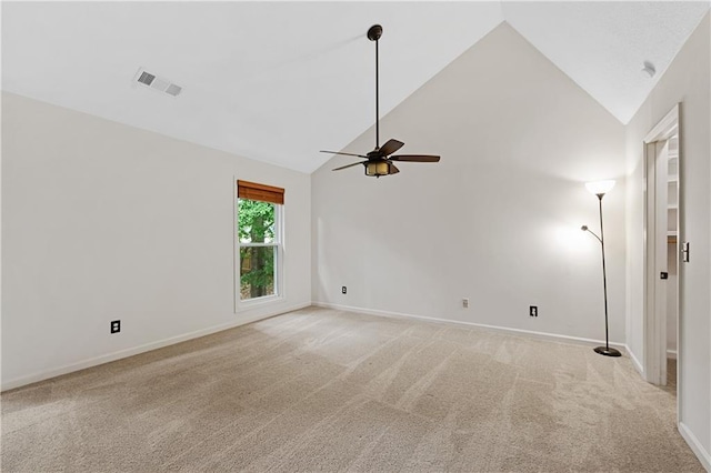 empty room featuring light carpet, ceiling fan, high vaulted ceiling, and baseboards