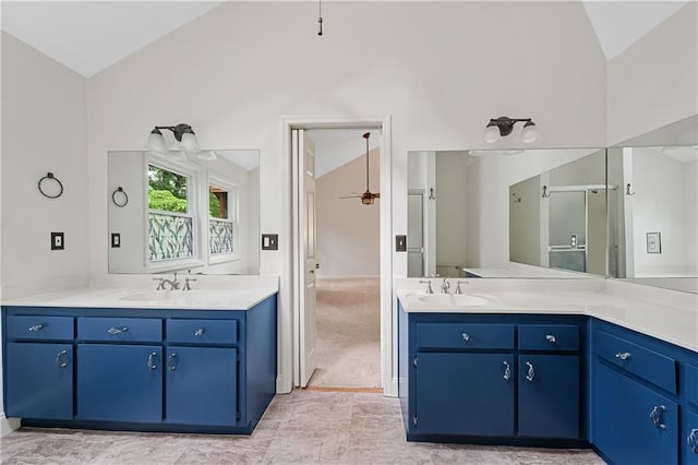 full bath featuring a ceiling fan, two vanities, and high vaulted ceiling