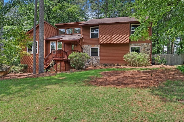 view of front facade featuring stone siding and stairway