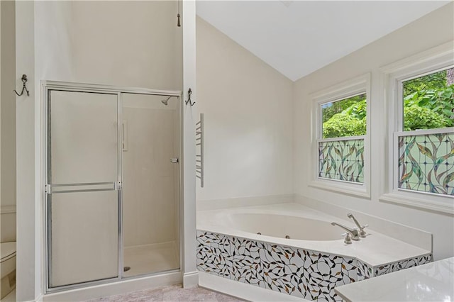 bathroom with a stall shower, lofted ceiling, a garden tub, and toilet
