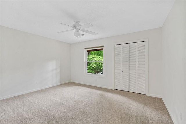 unfurnished bedroom featuring carpet flooring, baseboards, and a closet