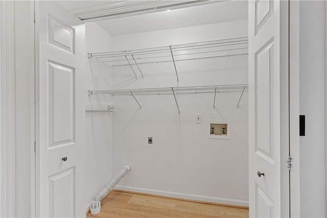 washroom featuring washer hookup, electric dryer hookup, and light wood finished floors