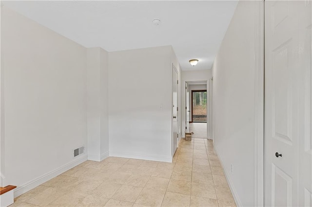 hall featuring baseboards