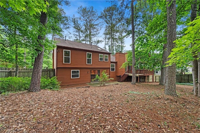back of house with a wooden deck, a patio, and stairway