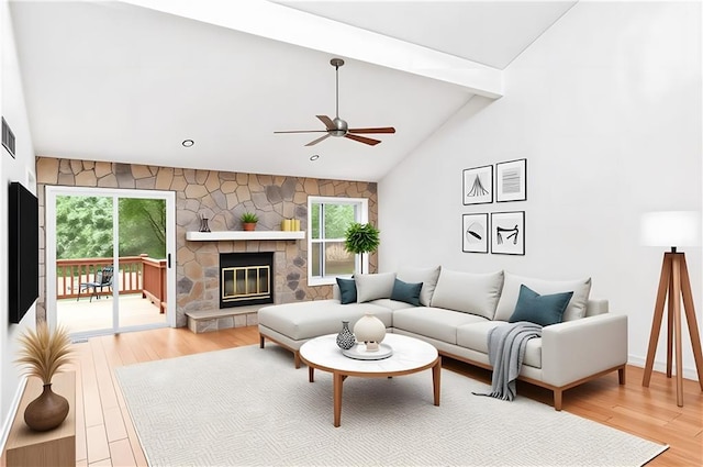 living area with ceiling fan, healthy amount of natural light, light wood-style floors, a fireplace, and high vaulted ceiling