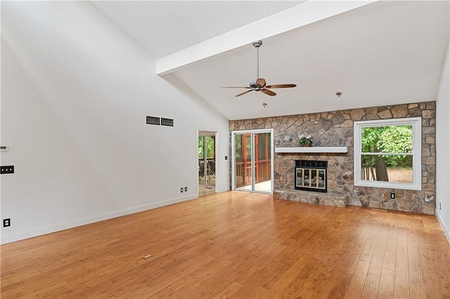 unfurnished living room featuring a ceiling fan, wood-type flooring, plenty of natural light, beamed ceiling, and high vaulted ceiling
